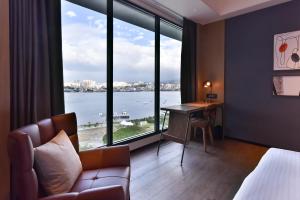 八里八里福朋喜来登酒店的酒店客房设有一张书桌和一个大窗户。
