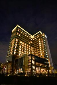 八里八里福朋喜来登酒店的一座高大的建筑,晚上有灯