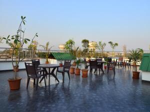 新德里Hotel Shri Vinayak at New Delhi Railway Station-By RCG Hotels的屋顶上带桌椅的天井