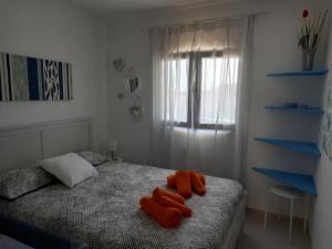 科拉雷侯Las Islas Apartment的一间卧室配有带橙色毛巾的床