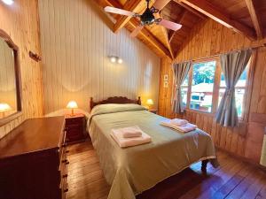 圣马丁德洛斯Villa Cümen的一间卧室配有一张床,上面有两条毛巾