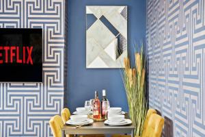 KentPlatinum Grove Modern Flat的一间设有桌子和蓝色墙壁的用餐室