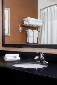 泰勒泰勒费尔菲尔德酒店及套房的浴室配有盥洗盆、镜子和毛巾