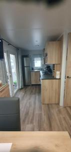 圣让-德蒙MH 476 annexe Bois Dormant的铺有木地板的厨房和带冰箱的厨房