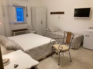 莫诺波利Il Casale Di Kevin的一间卧室配有一张床、一把椅子和一张沙发