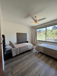 维拉卡洛斯帕兹Duplex en plena montaña的一间卧室配有两张床和吊扇