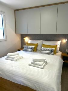 德拉格FJAKA luxury mobile home - Oaza Mira Camping Croatia的一张白色的大床,带两条毛巾