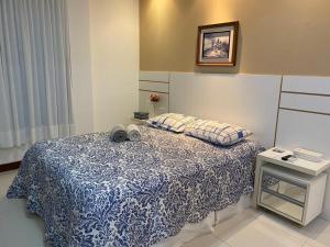普拉亚多CASA CONDOMÍNIO IBEROSTATE - RESORT IBEROSTAR的一间卧室配有一张带蓝白色毯子的床