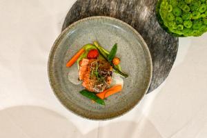 NeutalRestaurant & Hotel Dabuki的桌上一盘带肉和蔬菜的食物