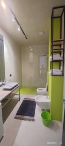 格勒姆Residence La Pineta的浴室设有2个卫生间和绿色的墙壁