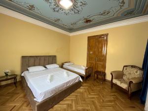 第比利斯Tiflisi Hostel的卧室配有一张白色大床和一把椅子