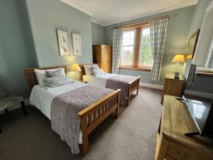 卢赫斯松林乡村别墅的酒店客房设有两张床和电视。