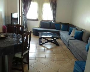 马拉喀什EDyar nakhil Appartement的客厅配有沙发和桌子