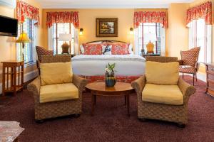 巴港Bass Cottage & Ullikana的一间卧室配有一张带两把椅子和一张桌子的床。