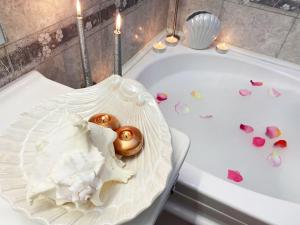 埃格尔Albina apartman的浴缸里装满了粉红色的心和蜡烛