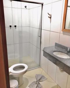 阿帕雷西达Santa Catarina Hotel的带淋浴、卫生间和盥洗盆的浴室