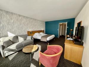 鲁伊萨塞Domaine de la Forêt d'Orient, Logis Hôtel, Restaurant, Spa et Golf的酒店客房设有一张沙发和一张床