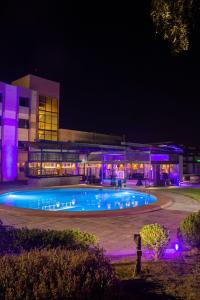 卡拉马阿瓜德尔德西尔托酒店的一座游泳池,在晚上在建筑物前