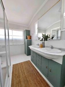 托雷德尔马尔Caleta Beach House Villa Beatriz Sinese Design的一间带水槽、镜子和淋浴的浴室