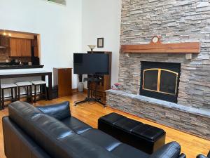 纽黑文Full loft-style apartment near Omni的客厅设有真皮沙发和石制壁炉