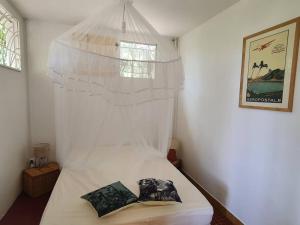 拉特里尼泰Villa Sunshine的卧室配有白色的华盖床