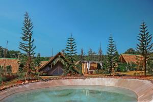 北冲Yellowstone Camps Resort Khao Yai的一座房子,后面有游泳池和树木