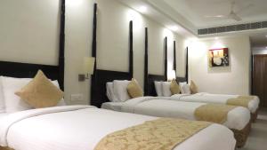 特里凡得琅Hotel Rajadhani的酒店房间一排四张床