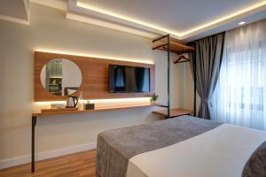 伊斯坦布尔Depiero Hotel Karaköy的酒店客房,配有床和镜子