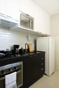 里约热内卢Art Inn Porto的厨房配有黑色台面和冰箱