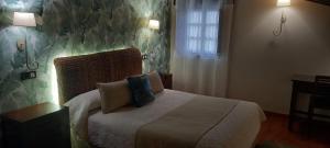 桑提亚纳德玛雷沃格卡索娜酒店的一间卧室配有一张带两个枕头的床