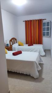宏达海滩Casa La Orilla 1的一间卧室设有两张床和窗户。