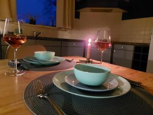阿克伦Luxe gastenverblijf in het hart van Friesland的一张桌子,上面放着蜡烛和两杯葡萄酒