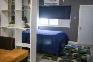 金斯敦Carter's Nest的一间卧室设有蓝色的床和白色的门