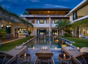 坎古Villa Pantai Indah - 100m to Pererenan Beach的一座带游泳池的房子的图象