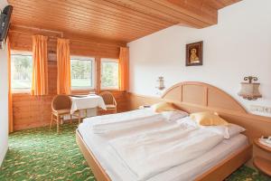 索普拉布扎诺利晨斯特恩酒店的一间卧室配有一张大床和一张桌子