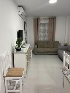 奇克拉纳－德拉弗龙特拉APARTAMENTO EN LOS GALLOS的客厅配有沙发和带电视的桌子