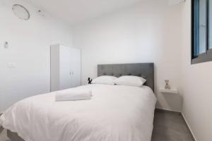 Or YehudaO&O Group - Luxury APT/3 BR/New Tower/Parking的白色卧室配有一张带白色床单和枕头的大床
