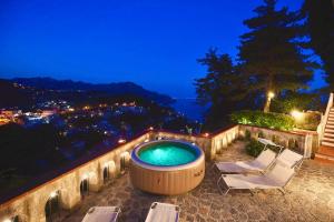 阿马尔菲Villa Nina Amalfi的美景按摩浴缸,配有两把躺椅