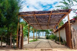 BarroquinhaBeira-mar Chácara Curimãs - Barroquinha, Ceará的海滩上一条小径上的木凉亭