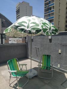 里约热内卢Suítes/Studios Privados Copacabana的屋顶上两把椅子和一把伞
