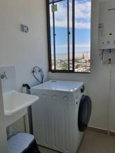 卡尔德拉Casa de descanso的一间带洗衣机和窗户的浴室