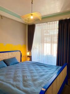 河内Homestay Casa 69的一间卧室设有蓝色的床和窗户。