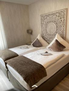 弗雷兴Hotel Haus Loewe的一间卧室配有两张带枕头的床。