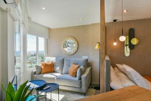 马拉加Apartamento a un paso del mar的客厅设有蓝色的沙发和窗户。