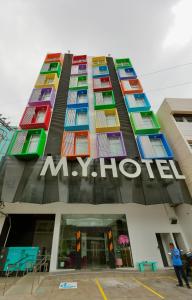 杜马格特M.Y. Hotel的一座大型建筑,有五颜六色的窗户和标志