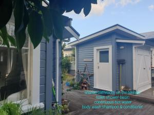 莫图伊卡Cabins on Tudor bed & breakfast的院子里有白色门的蓝色棚子