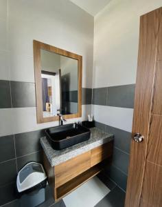 潘切Trường Phúc Vinh Hotel的浴室设有黑色水槽和镜子