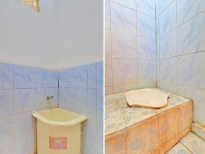 CupelSPOT ON 92404 Pondok Ai的瓷砖浴室设有卫生间和水槽
