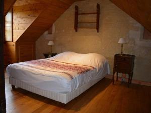 Saint-Martin-des-EntréesManoir de Danigny的一间卧室设有床、两张桌子和一扇窗户