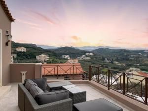 普拉塔尼亚斯La Casa Di Manou的阳台配有沙发,享有山景